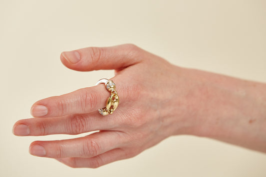 Bold sculptural ring in polished mixed metals with oversized link design. A modern, industrial-chic statement piece with high shine and edge.