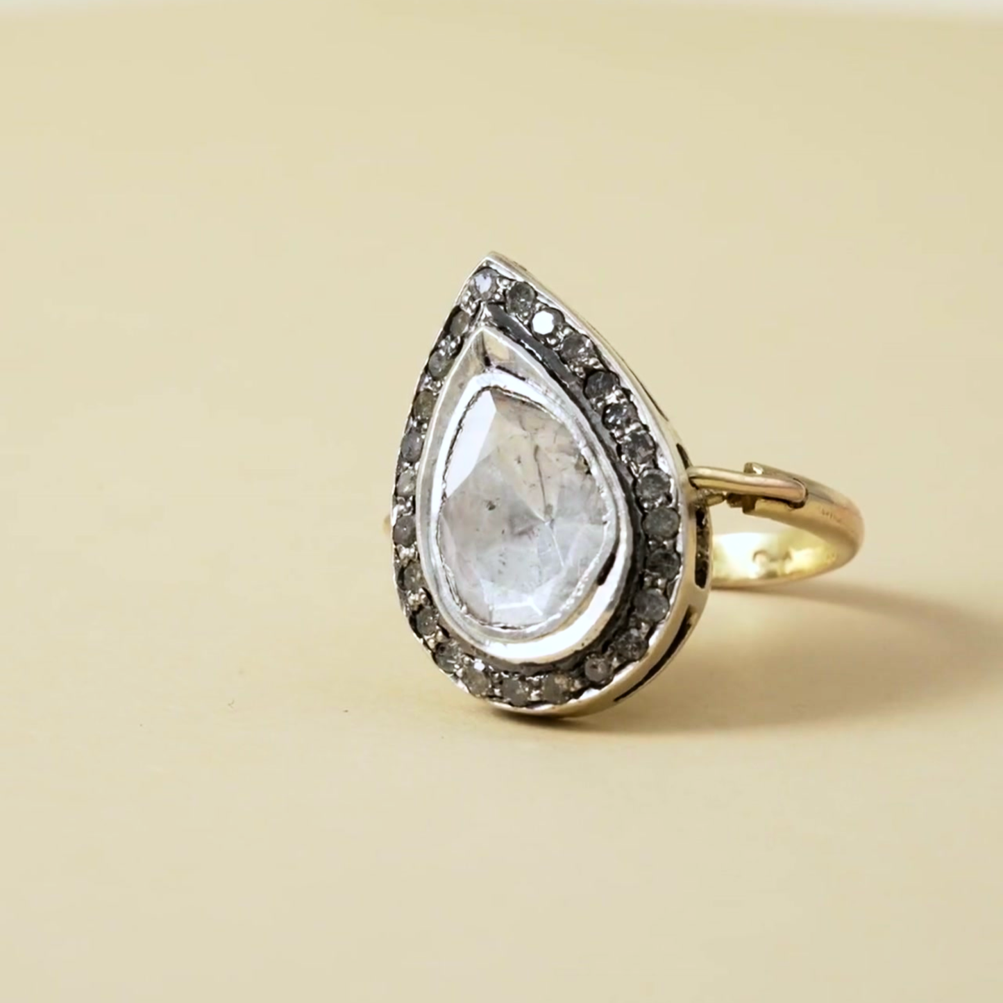 Sterling silver ring with large pearshaped polki stone and darkened halo. A regal, heritage-inspired statement of bold elegance.