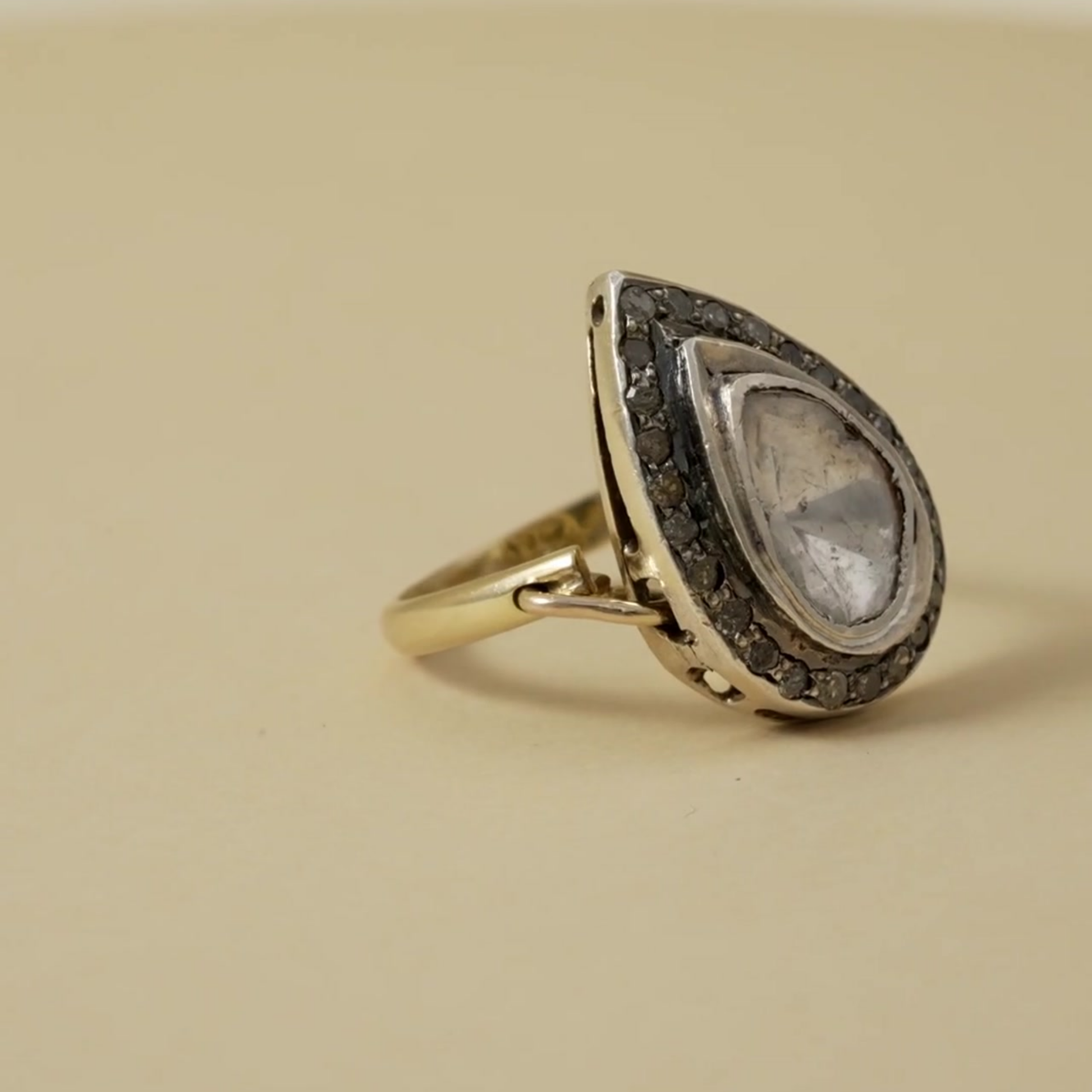 Sterling silver ring with large pearshaped polki stone and darkened halo. A regal, heritage-inspired statement of bold elegance.
