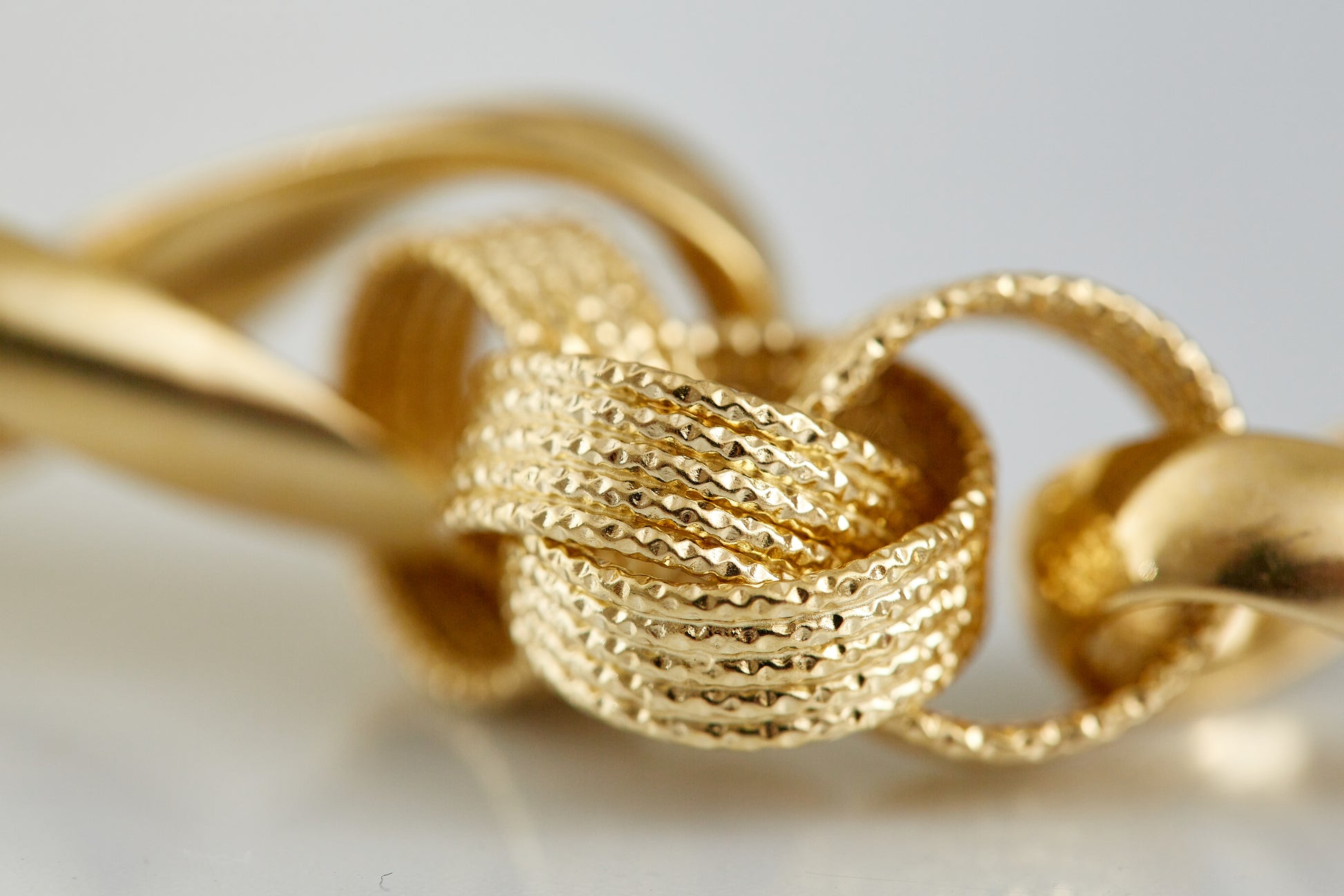 Crafted in 18K gold, this sculptural textured-link bracelet combines polished and woven finishes for a striking statement of vintage luxury. A collectible design for bold gold lovers.
