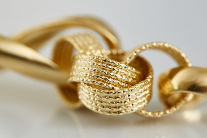 Crafted in 18K gold, this sculptural textured-link bracelet combines polished and woven finishes for a striking statement of vintage luxury. A collectible design for bold gold lovers.

