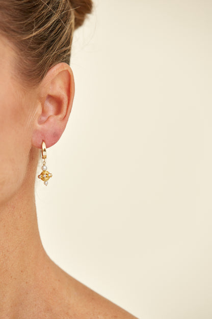Classic drop earrings featuring delicate pearls set in ornate 18K yellow gold. A timeless design echoing vintage South Asian craftsmanship.
