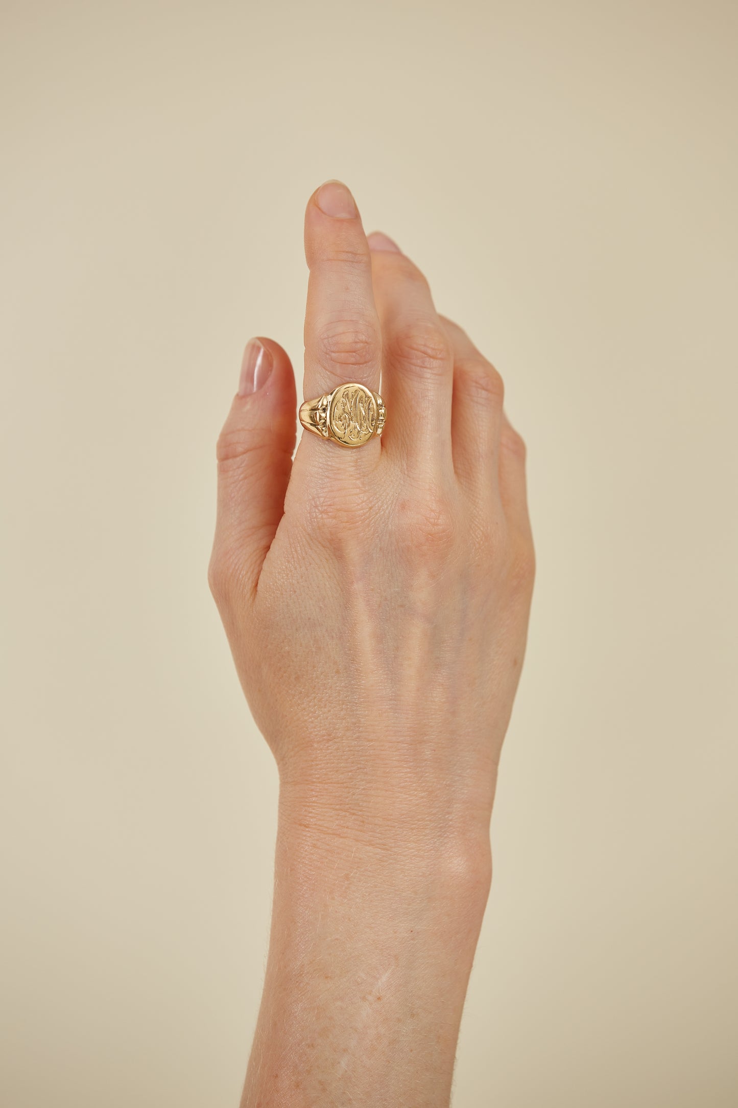 Classic 18K gold signet ring with intricate engraving. A timeless heirloom piece, rich in character and personal style.
