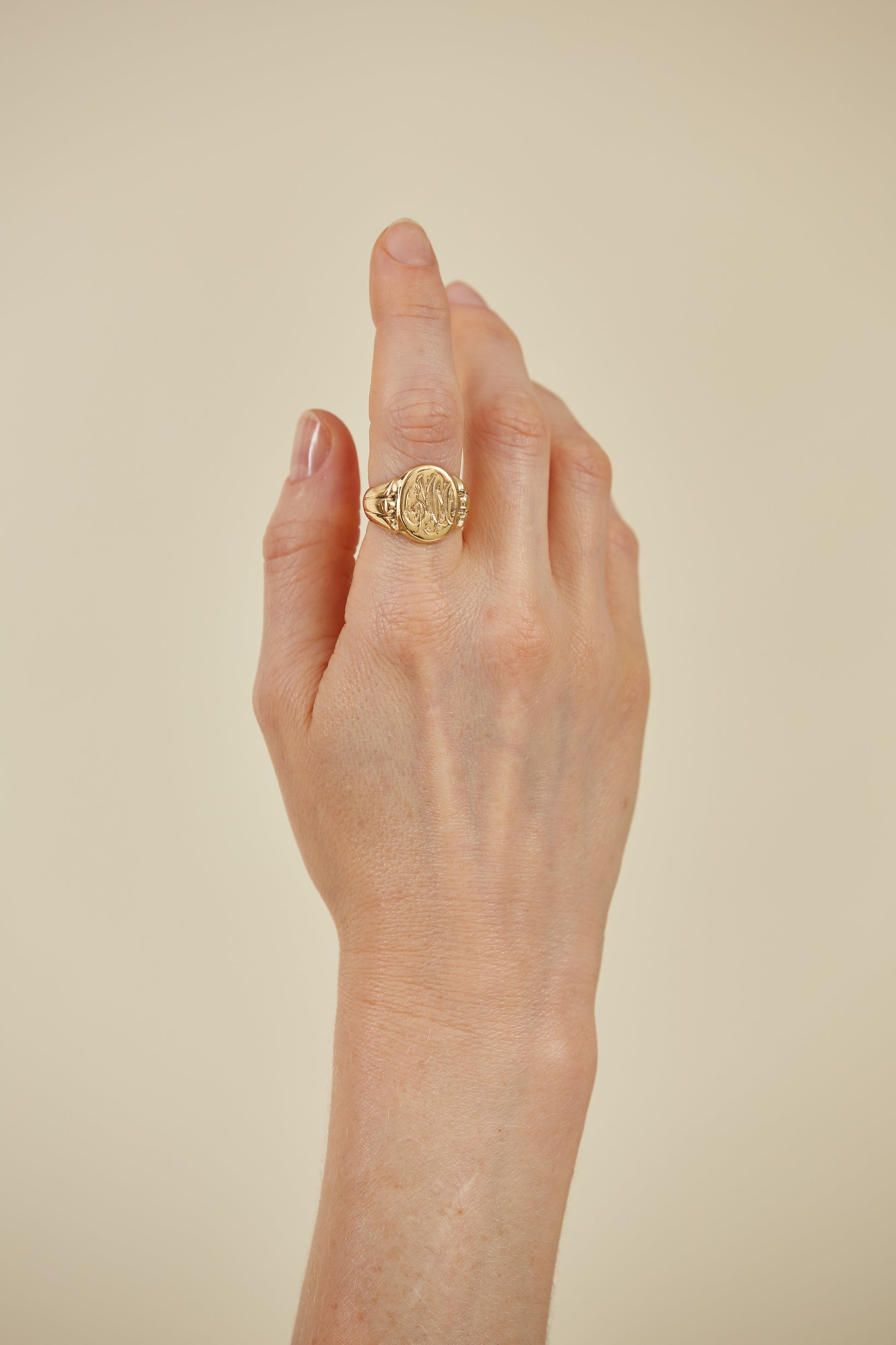 Classic 18K gold signet ring with intricate engraving. A timeless heirloom piece, rich in character and personal style.

