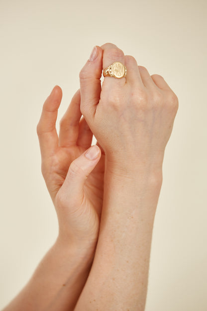 Classic 18K gold signet ring with intricate engraving. A timeless heirloom piece, rich in character and personal style.
