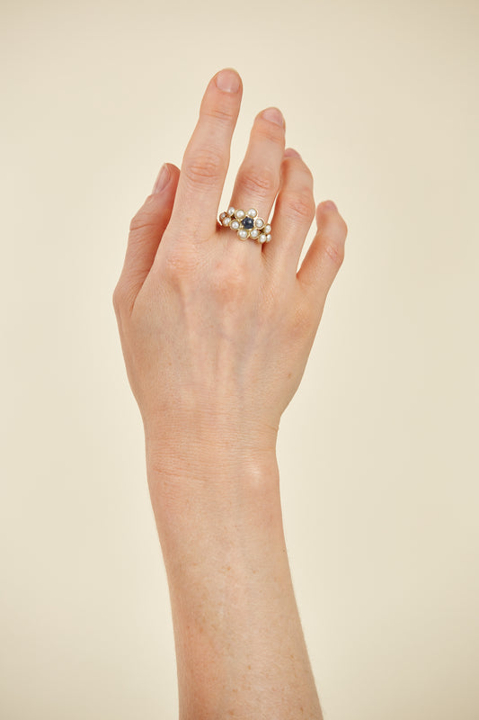 Half pearls with Cabochon Sapphire accent in 9 Kt yellow gold