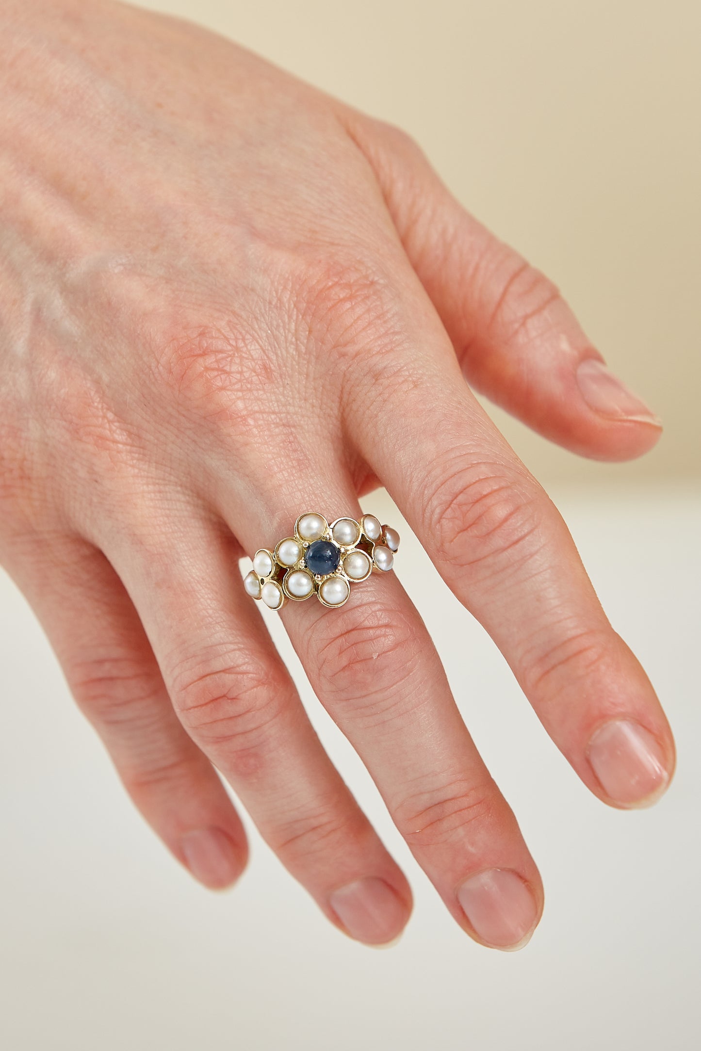 Half pearls with Cabochon Sapphire accent in 9 Kt yellow gold
