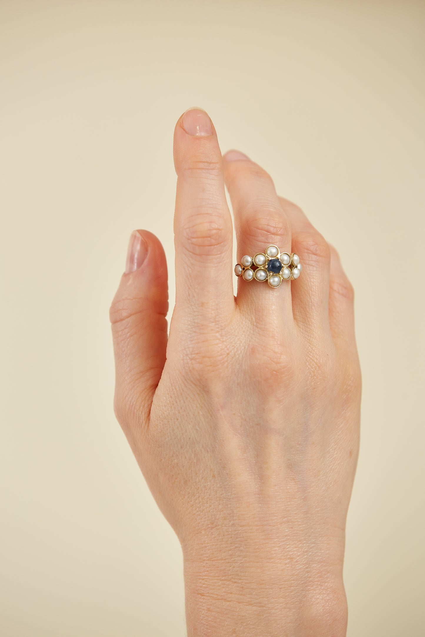 Half pearls with Cabochon Sapphire accent in 9 Kt yellow gold