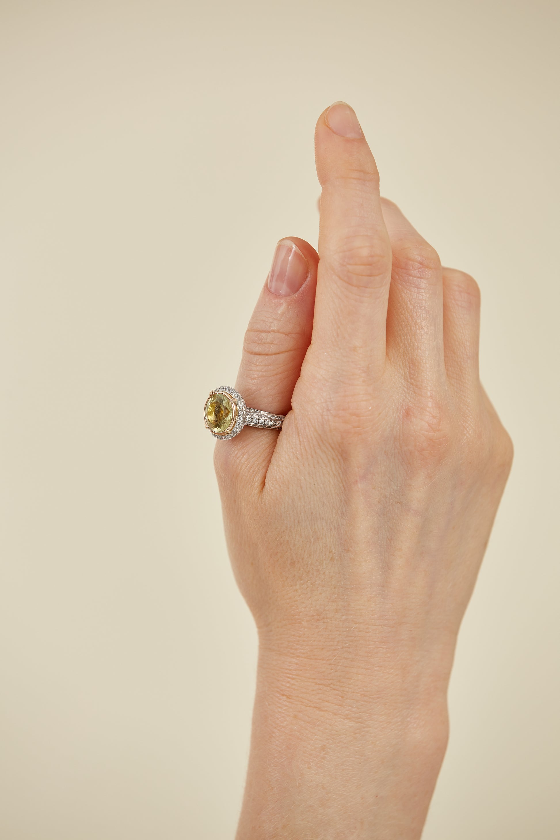Elegant platinum ring featuring a yellow quartz centre stone, diamond pavé band, and gold bezel. A timeless mix of colour, sparkle, and refinement.
