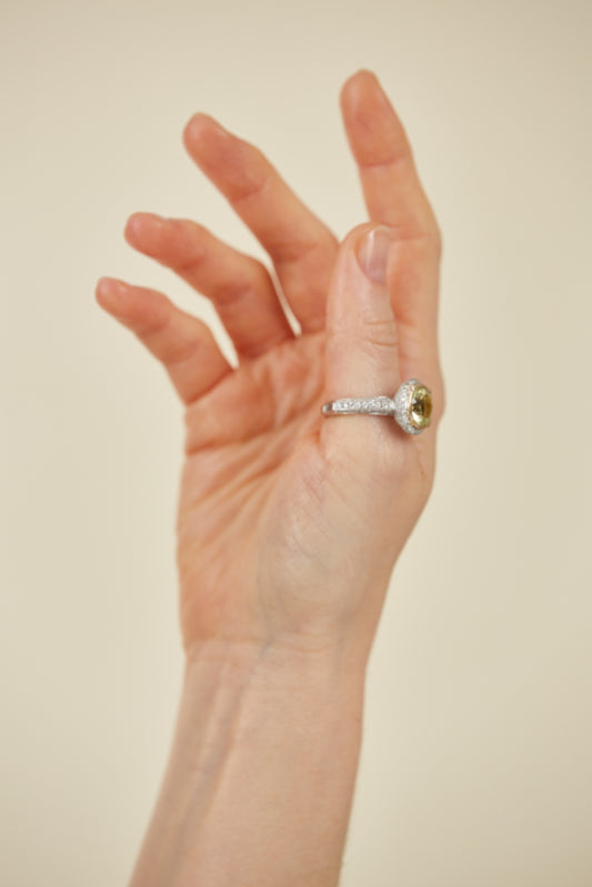 Elegant platinum ring featuring a yellow quartz centre stone, diamond pavé band, and gold bezel. A timeless mix of colour, sparkle, and refinement.
